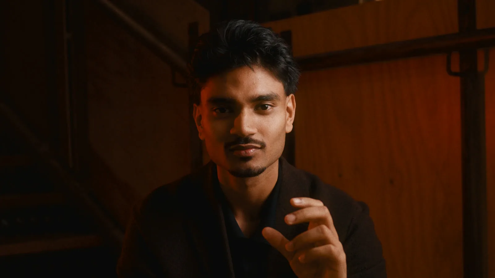 A man sitting on wooden stairs, in the City Lights look